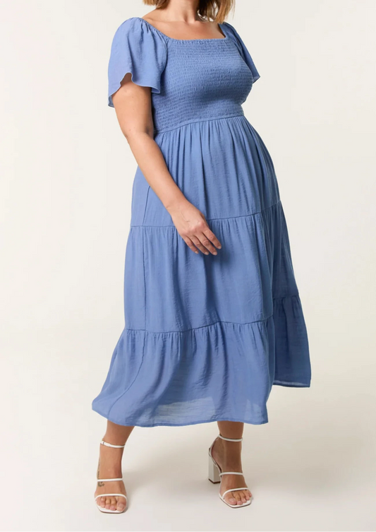 Woman wearing a blue dress on a white background