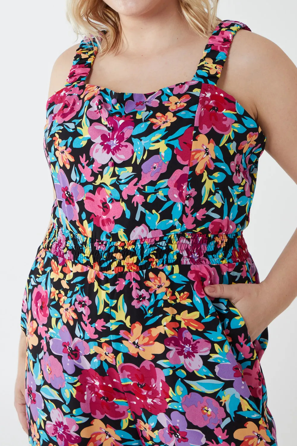 Woman wearing a colorful floral dress on a white background